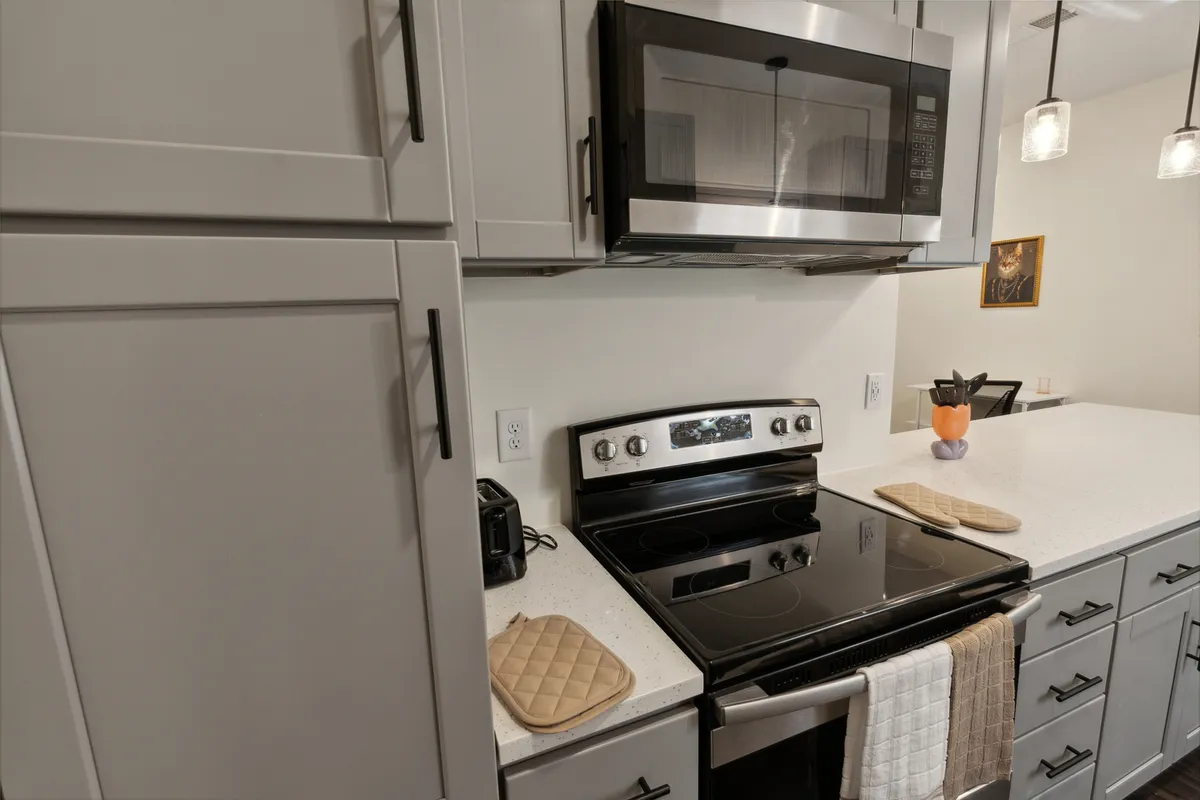 This image captures a modern kitchen with stainless steel appliances, a smooth countertop, and tasteful decorative touches. The inviting space is well-lit and designed for gathering, making it an ideal spot for friends to cook, entertain, or enjoy a casual meal together after a day of exploring the city's craft beverage scene.